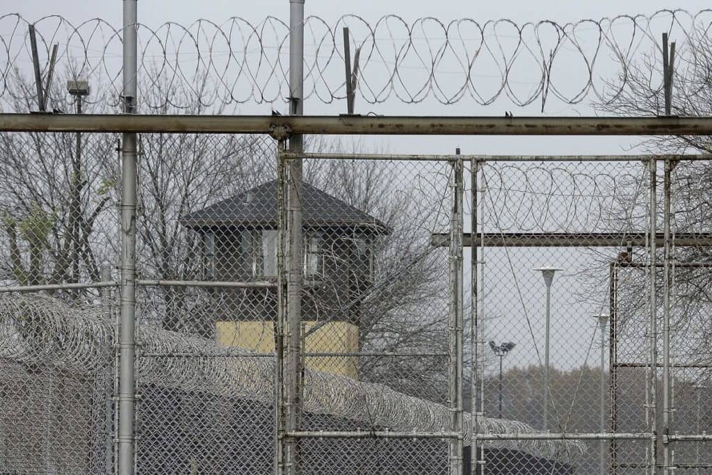 FILE - Security fences surround the Illinois Department of Corrections' Logan Correctional Center on Nov. 18, 2016, in Lincoln, Ill. A report Tuesday, Sept. 20, 2022, by a state inspector general found that an Illinois prison system administrator improperly ordered the hiring of a family member for a Department of Corrections position that was never authorized. (AP Photo/Seth Perlman, File)