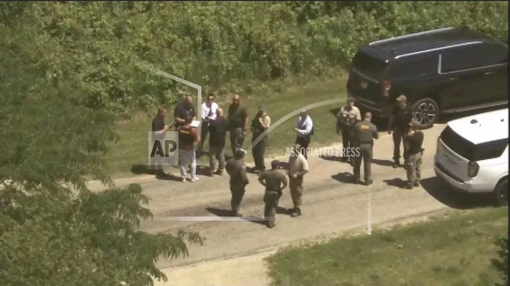 This photo taken from aerial video by WLS-TV/ABC 7 Chicago shows law enforcement gathering after multiple sheriff’s deputies were shot while responding to a home Wednesday, June 12, 2024, in Dixon, Ill. Authorities say the suspect was also wounded. (WLS-TV/ABC 7 Chicago via AP)