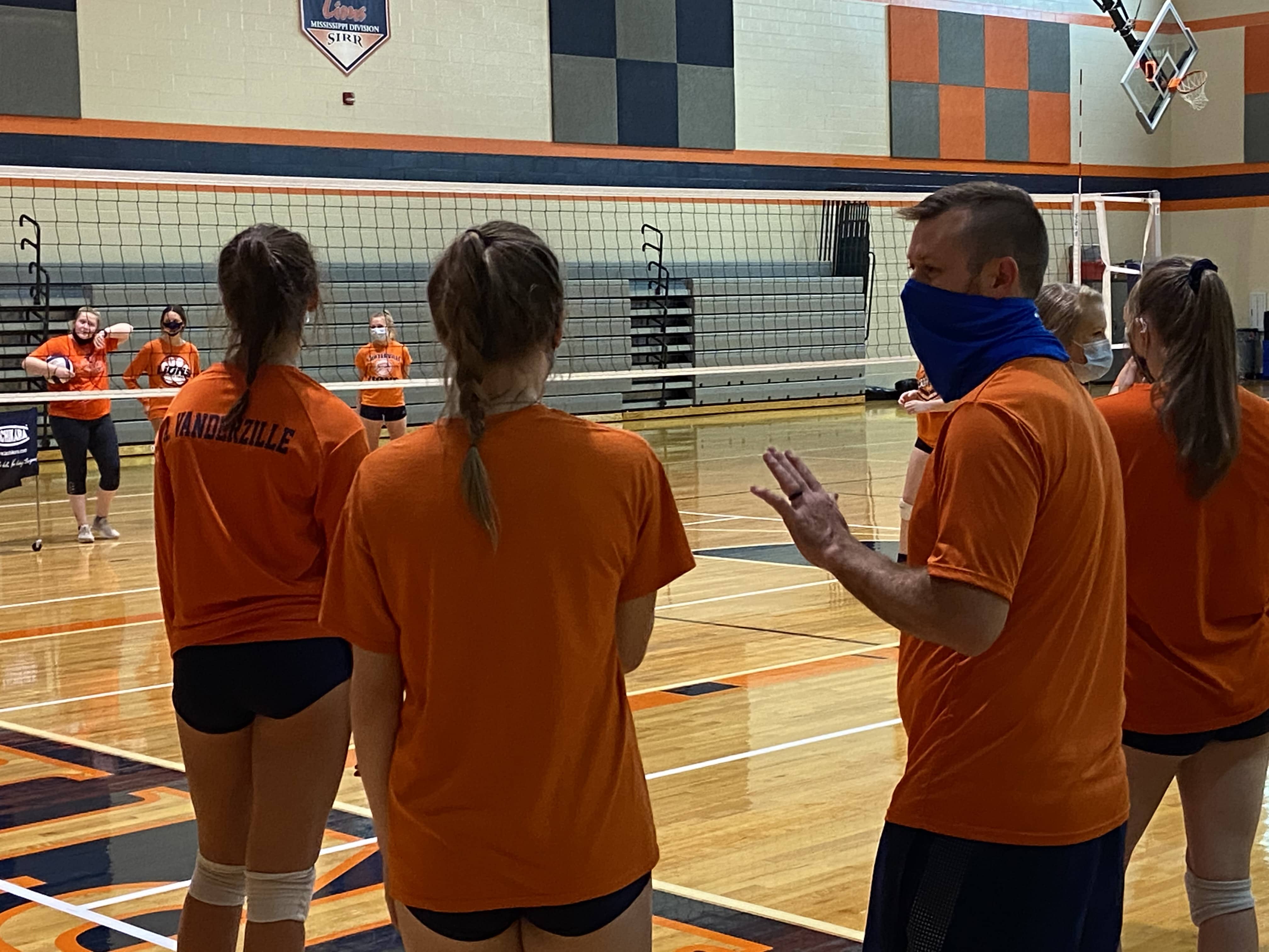 Carterville Volleyball coach Nathan Emrick instructs his players in a contact day practice in October 2020