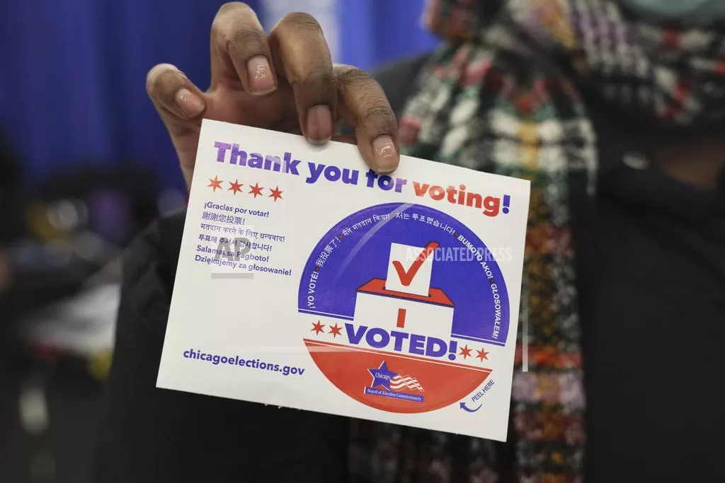 FILE - A voter shows her "I voted" sticker after casting her ballot in Chicago, March 19, 2024. (AP Photo/Teresa Crawford, File)