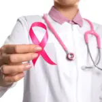 doctorwithpinkribbonandstethoscopeonwhitebackgroundcloseup