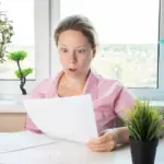 womansurprisedbyutilitybillsshockedwomanlookingatletter