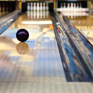 swirling-bowling-ball-is-rolling-down-the-path-to-the-bowling-pins
