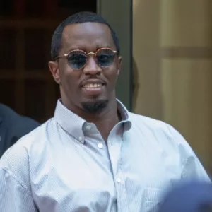 Sean “Diddy” Combs exiting the Crosby Street Hotel and heading to a waiting line of black SUV's surrounded by paparazzi and flanked by security. Lower Manhattan NYC^ New York / USA - July 24^ 2019