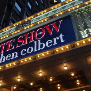 Manhattan NYC buildings in Times Square^ Broadway street avenue road^ signs for Stephen Colbert Late Show- Marquee / Theatre at Night