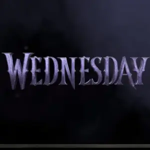 TV on black wall. TV screen playing Netflix series 'Wednesday' trailer