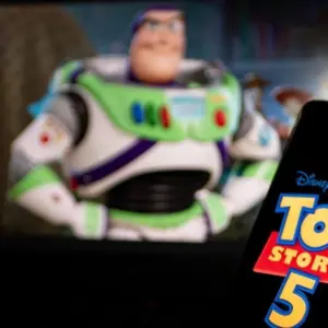 New Disney film Toy Story 5. A man's hand holds a phone with a poster of the new cartoon Toy Story 5 by Pixar. Moscow November 2025.
