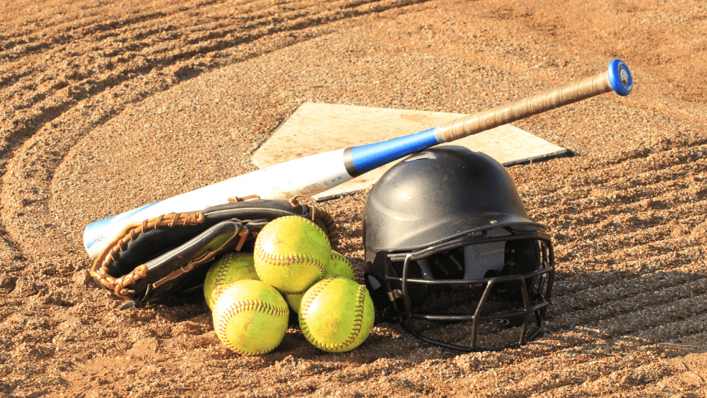 softball-gear-in-front-of-home-plate