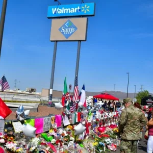 Flowers^ posters^ toys and other memorabilia left for the victims of the Walmart shooting on 3 August 2019. El Paso^ Texas / USA - August 2019