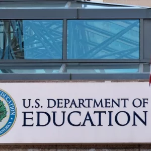 The exterior sign and US flag in front of the U.S. Department of Education offices. Washington^ DC USA; September 5^ 2024: