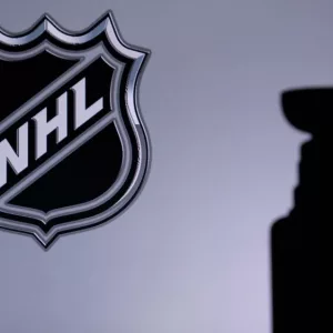 National Hockey LeagueLogo of NHL club on the screen. Stenley Cup Trophy Silhouette.