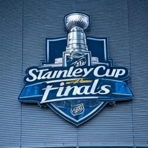 the front facade of a hockey arena with the NHL Stanley Cup Finals logo on the front of the building.