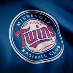 Close-up of waving flag with Minnesota Twins MLB baseball team logo^ seamless loop. Editorial footage
