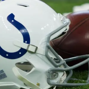 Indianapolis Colts helmet shown on field next to football; Colts host the Oakland Raiders on 9/29/19 at Lucas Oil Stadium in Indianapolis IN-USA