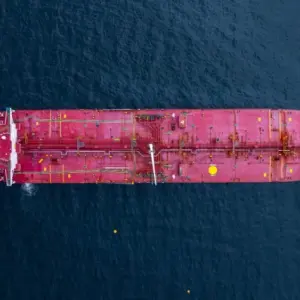 Aerial view crude oil tanker ship at sea^ Red crude oil tanker ship top view^ Logistic and maritime transpoprtation of petroleum^ Modern offshore terminal loading tanker ship.