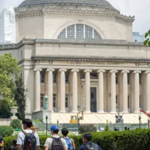 Students at the Columbia University campus on the Upper West Side of Manhattan. Steps of the Low Memorial Library in the background. New York^ NY^ USA - July 8^ 2022: