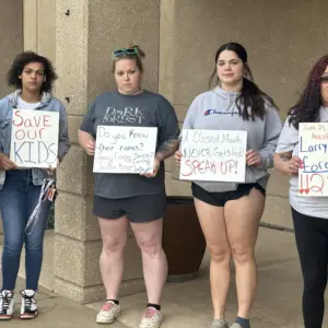 26-0423-five-women-with-signs-outside-marshall-cc