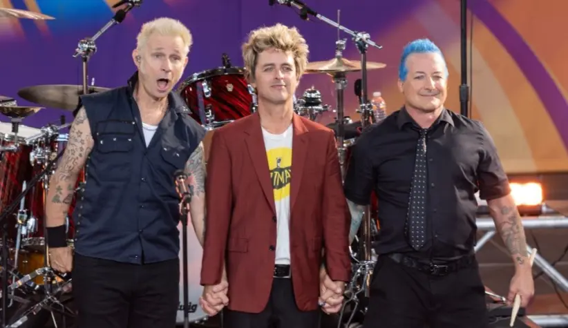 Mike Dirnt^ Billie Joe Armstrong^ Tre Cool pose on stage during ABC Good Morning America rock group Green Day concert in Central Park in New York on July 26^ 2024