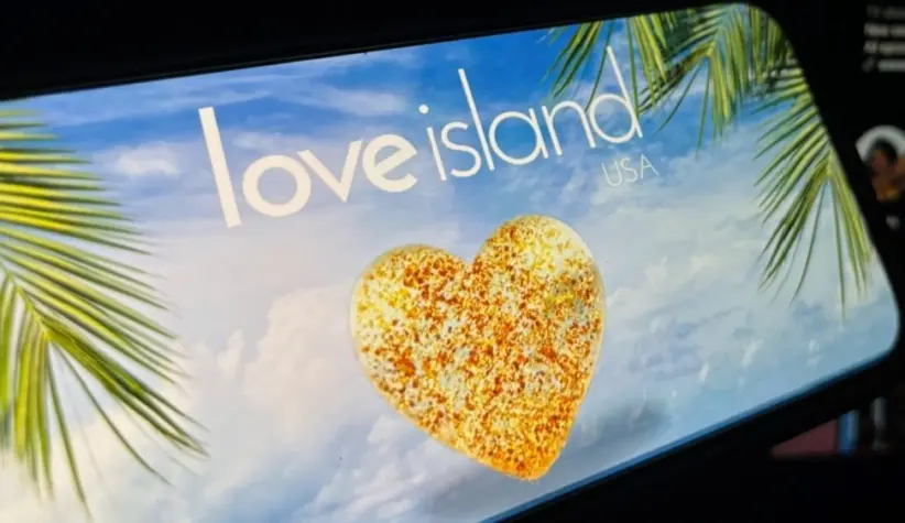 '2025 Love Island'' shown on a smart phone. is a reality dating show that originated in the UK. The premise involves a group of singles living together in a luxurious villa^ where they couple up Toronto^ Canada - June 5