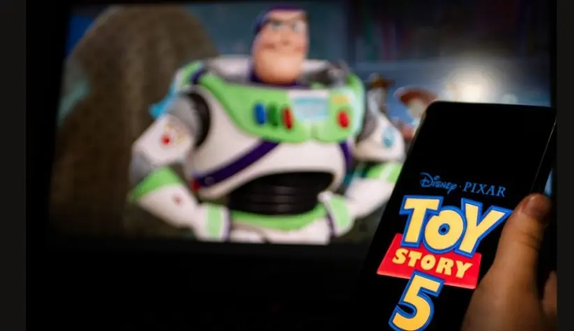 New Disney film Toy Story 5. A man's hand holds a phone with a poster of the new cartoon Toy Story 5 by Pixar. Moscow November 2025.