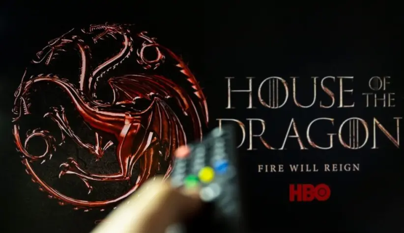 House of the Dragon HBO TV series on TV with remote control in hand. Focuse on the tv screen. Story takes place 300 years before events portrayed in Game of Thrones