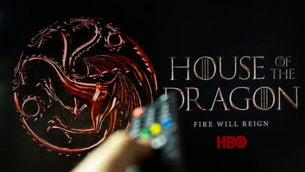 House of the Dragon HBO TV series on TV with remote control in hand. Focuse on the tv screen. Story takes place 300 years before events portrayed in Game of Thrones
