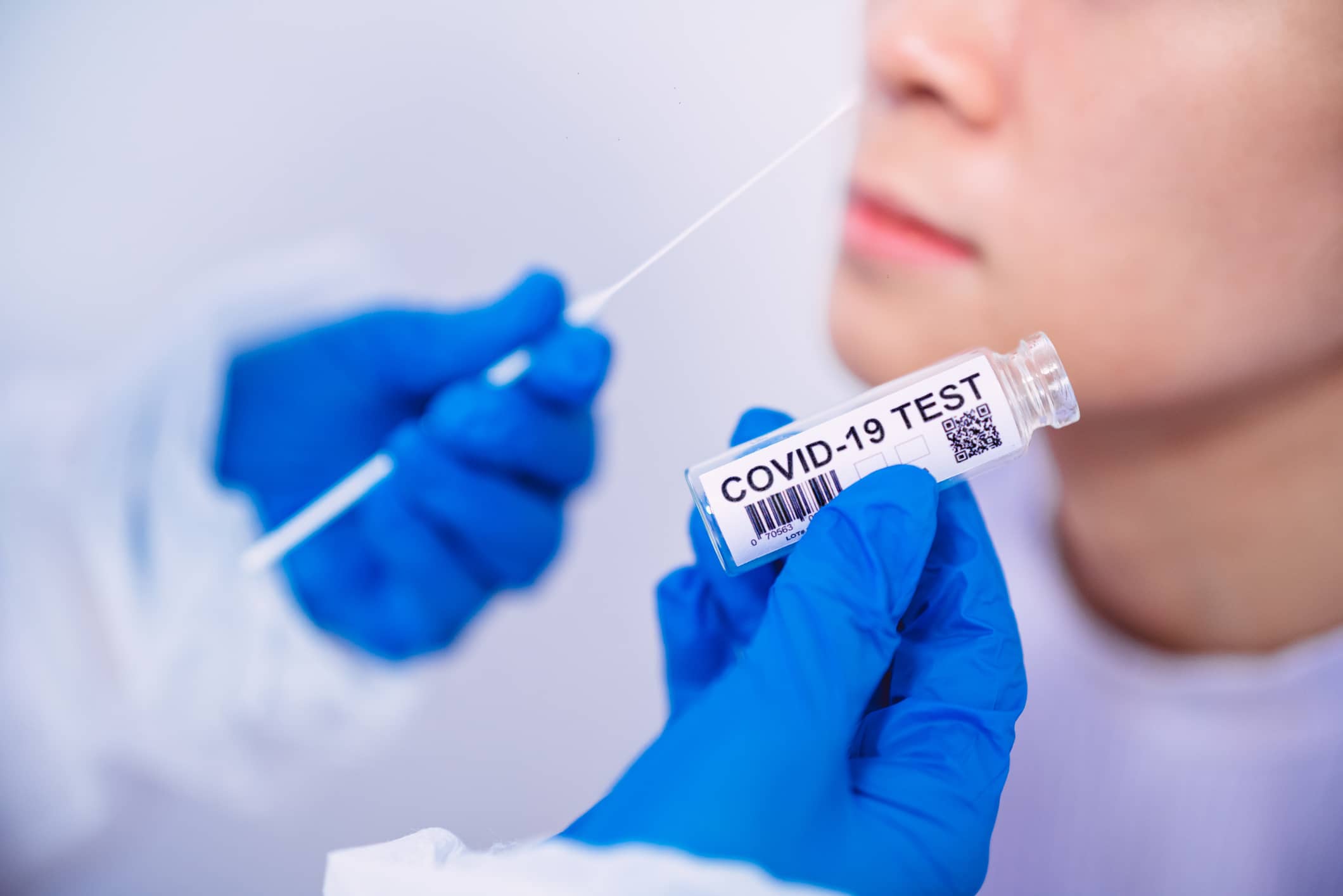 doctor-in-protective-gloves-workwear-holding-testing-kit-for-the-coronavirus-test