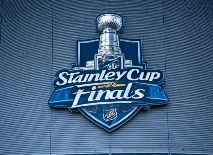the front facade of a hockey arena with the NHL Stanley Cup Finals logo on the front of the building.