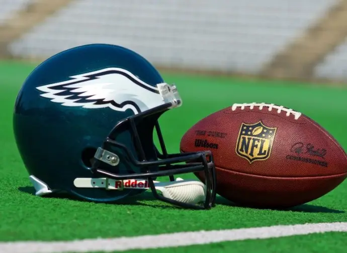 Philadelphia eagles equipment ^ ball and helmet on the green playing field ^ product shot AUGUST 13^ 2015