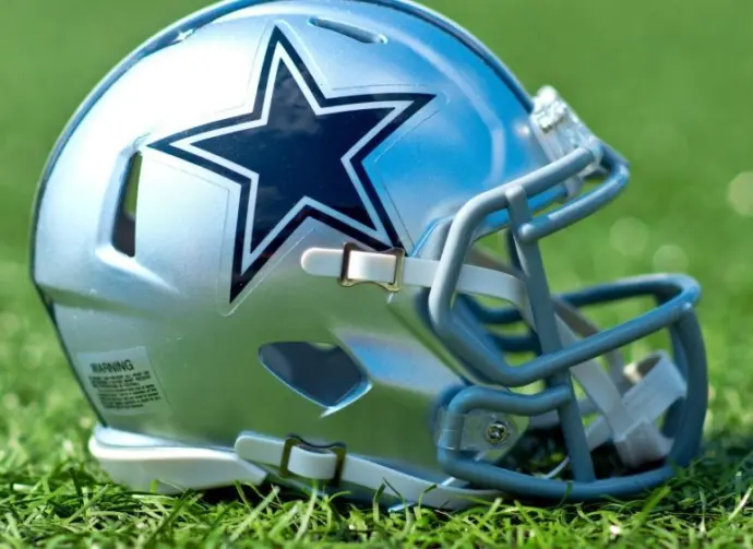 NFL Dallas Cowboys replica helmet on artificial grass playing turf ^ product shot