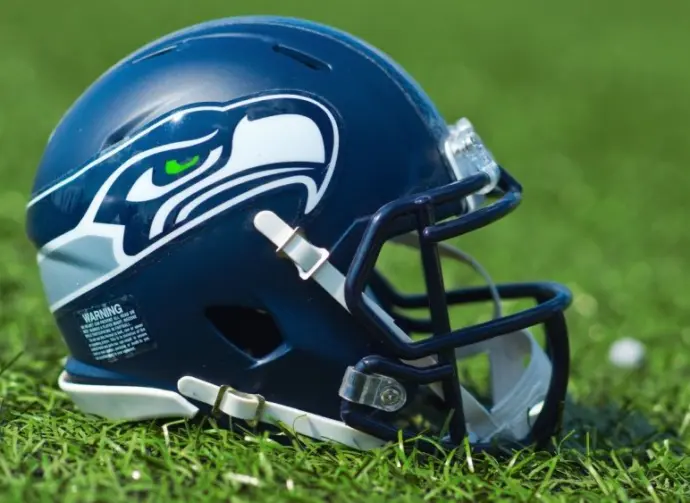 NFL Seattle Seahawks replica helmet on artificial grass playing turf ^ product shot