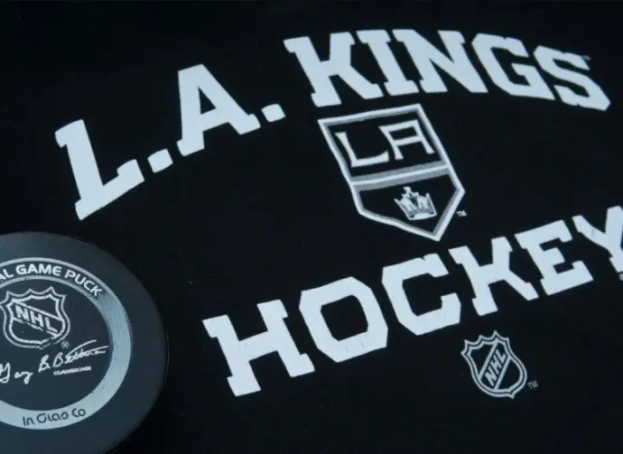Official NHL game puck with LA kings equipment ^ product shot