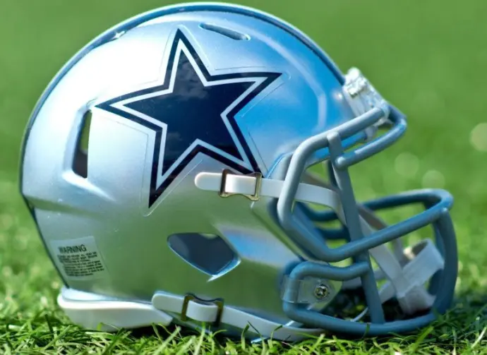 NFL Dallas Cowboys helmet on artificial grass playing turf ^ product shot