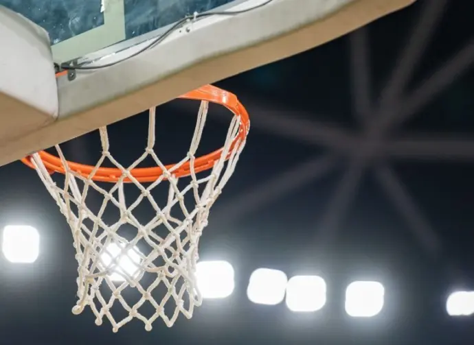 Basketball hoop hanging in a sports stadium waiting for the ball