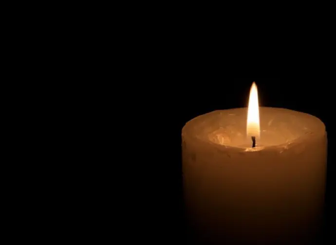One big burning candles. Bright light on black background. RIP darkness template. Romantic evening on Valentine.