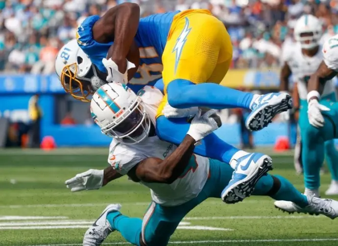 Los Angeles Chargers wide receiver Mike Williams (TOP) is brought down by Miami Dolphins cornerback Kader Kohou (BOTTOM) during an NFL football game^ Sept. 10^ 2023^ in Inglewood^ Calif.