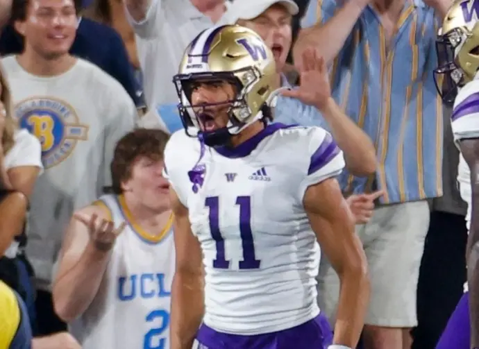 Washington's Jalen McMillan (11) celebrates with teammates after scoring a touchdown against the UCLA during an NCAA college football game Friday^ Sept. 30^ 2022^ in Pasadena^ Calif.