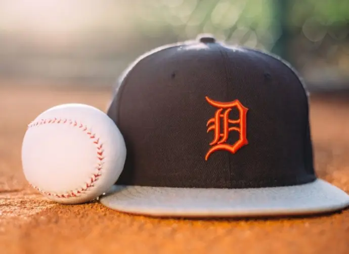 MLB Baseball ball with Detroit Tigers cap on pitchers mound.