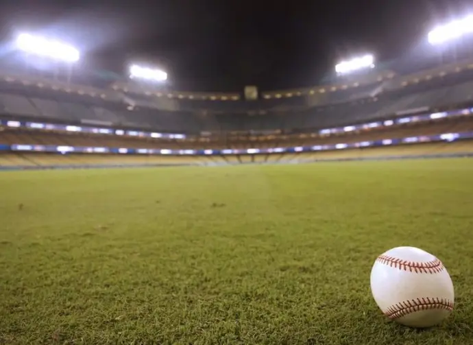 Selective focus of baseball in outfield grass at Dodger Stadium Los Angeles - October 12^ 2022