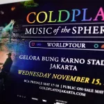 Website for the Coldplay 'Music Of The Sphere' world tour concert^ shown on laptop computer screen