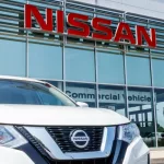 New vehicles at a Nissan Car and SUV Dealership. Nissan is part of the Renault–Nissan Alliance VII