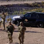 National Guard troops and Texas State Troopers deployed to the border to deter migrants from crossing. El Paso^ TX USA December 21^ 2022