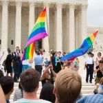 Crowd waving flags in support of LGBTQ community gathers at the U.S. Supreme Court ; WASHINGTON June 26^ 2015