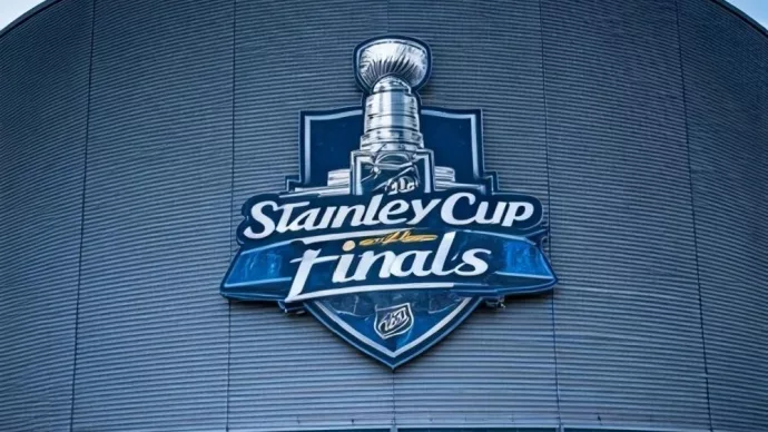 the front facade of a hockey arena with the NHL Stanley Cup Finals logo on the front of the building.