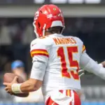 KC Chiefs quarterback Patrick Mahomes #15 runs to escape a tackle by LA Chargers outside linebacker Bud Dupree #48 during an NFL football game at SoFi Stadium^ Aug. 17^ 2024^ in Inglewood^ Calif.