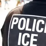 Ice police agent - Officer of Immigration and Customs Enforcement. Close up of POLICE ICE on back of stab proof vest worn by DHS Department of Homeland Security police officer at the scene of incident