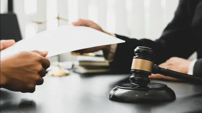 Consulting and finding a solution Concept^ businesspeople consult with a lawyer or judge to find out about business fraud.