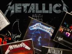 CDs of the heavy metal group Metallica over on a T-shirt with the Metallica logo. Illustrative editorial Leon-Spain-12 March 2024