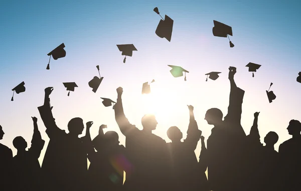 depositphotos_116379142-stock-photo-silhouettes-of-students-throwing-mortarboards