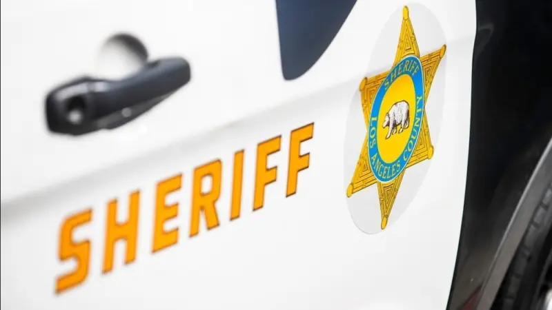 Close-up of a Los Angeles County Sheriff's Department badge and lettering on the side of a patrol vehicle. 2024-11-15 Los Angeles USA